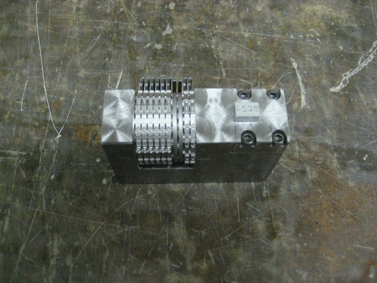 Pictured is the Model 70P manual numbering machine.  with an extended frame leg with a pocket for
a logo die.  Customer needed a certain distance from the wheels to the logo die.  The logo die is retained by a set screw and can be easily changed.  As always MADE IN USA!