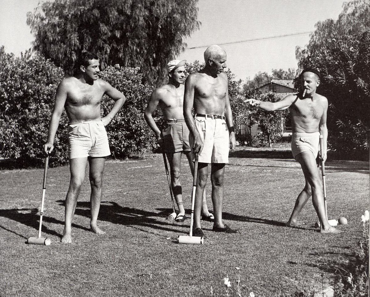 Cesar Romero, Tyrone Power, Howard Hawks and Darryl Zanuck playing a game o...