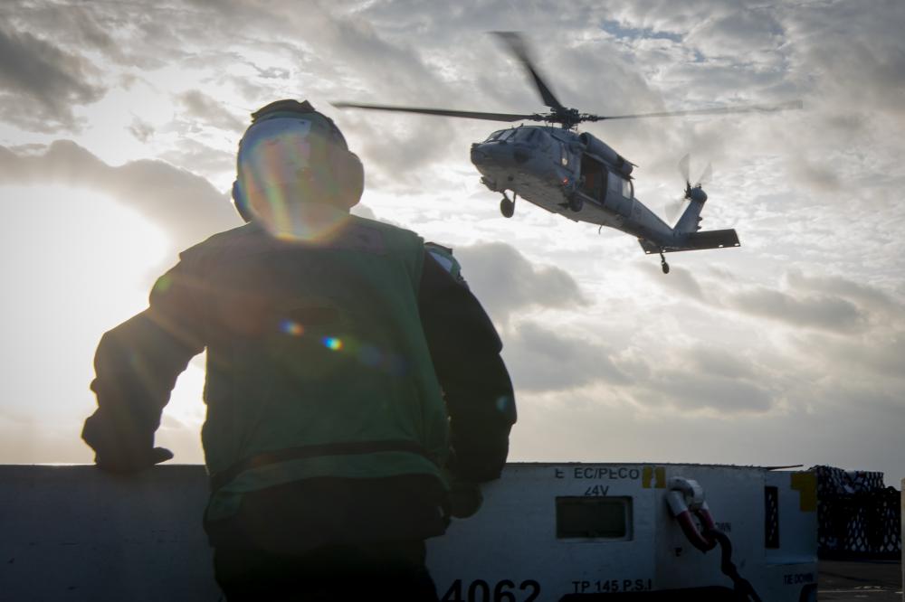 An MH-60S Sea Hawk, assigned to the “Island Knights” of Helicopter Sea Combat Squadron, transports supplies to @CVN70 during a vertical replenishment-at-sea with #USNSMatthewPerry