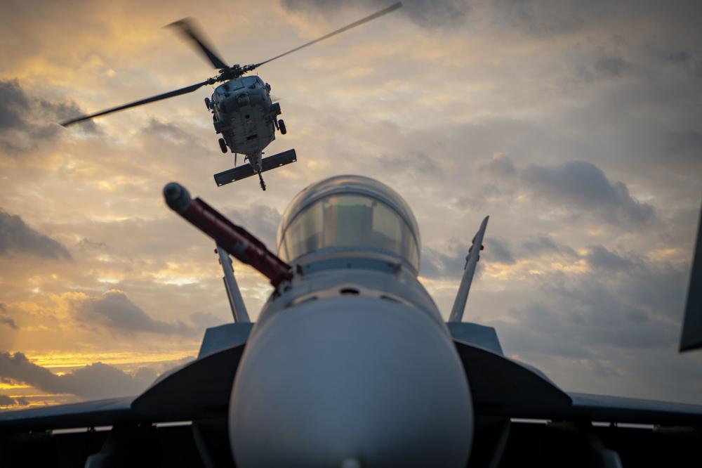 USPACOM's tweet photo. An MH-60S Sea Hawk, assigned to the “Island Knights” of Helicopter Sea Combat Squadron, transports supplies to @CVN70 during a vertical replenishment-at-sea with #USNSMatthewPerry. #FreeandOpenIndoPacific #PhilippineSea #Readiness https://t.co/PYk6S88sle