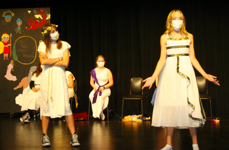 Our 8th grade cast of "The Greek Mythology Olympiaganza" perform on stage during one of our final rehearsals!
