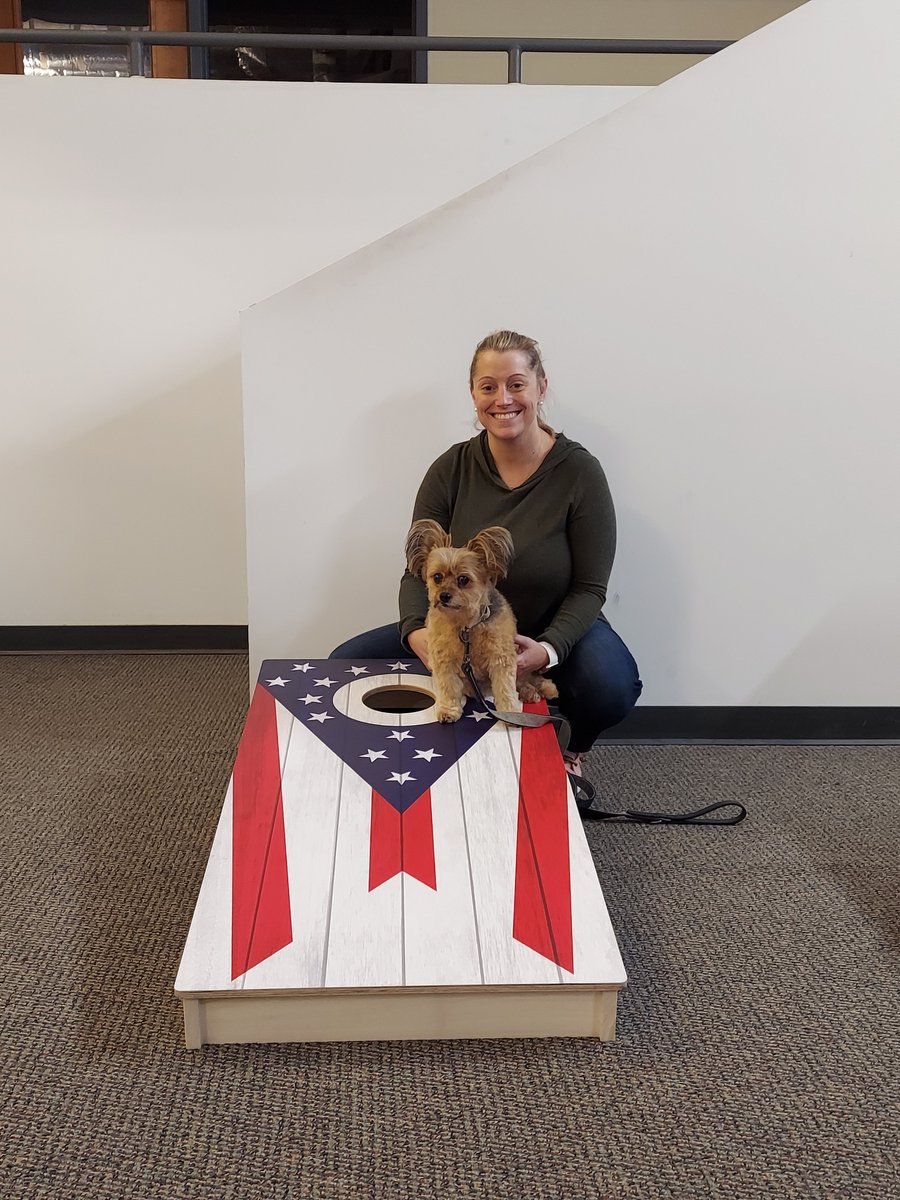 SikoraLaw's tweet photo. So nice that our office can be a place to accomplish great things for our Clients and to have some fun.  Our Attorney, Angela Hare, enjoys the sweet rewards of victory with her pooch, after winning Sikora Law’s first annual Cornhole Tournament. https://t.co/HLA1QPQ90l