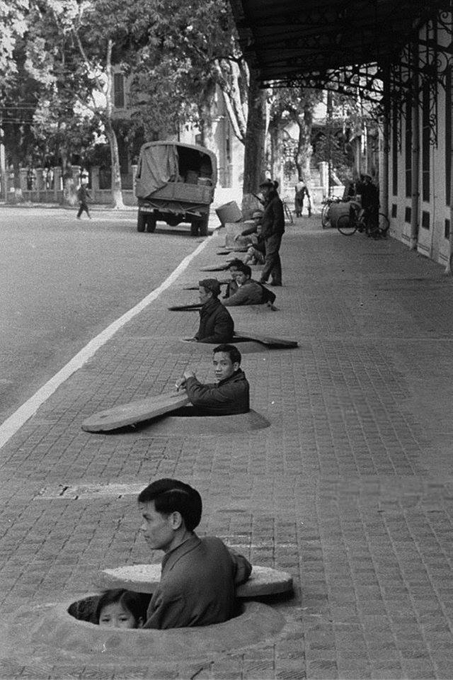 tjevsejevas's tweet photo. "Residents of Hanoi wait in chest-deep sidewalk shelters for the all clear signal, during an air raid alert. Hanoi, North Vietnam, 1967."

#Hanoi #Vietnam https://t.co/S6OBabolUs