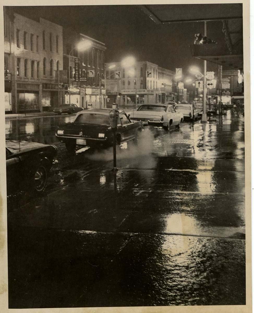 From our collection: a view of the "#Rain Glistened City" looking west along East Front Street. Downtown Monroe, Michigan, April 30, 1970. #Museum30