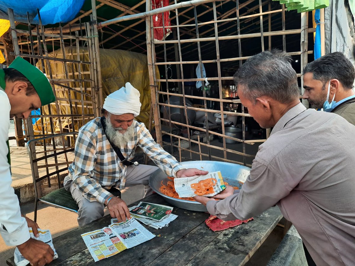 the_hindu's tweet photo. #FarmLaws | K.P. Gill, a farmer distributing sweets at the Ghazipur border. "The decision gives us a feeling that we exist." https://t.co/5e846BqmuY https://t.co/9z3O0rvSRE