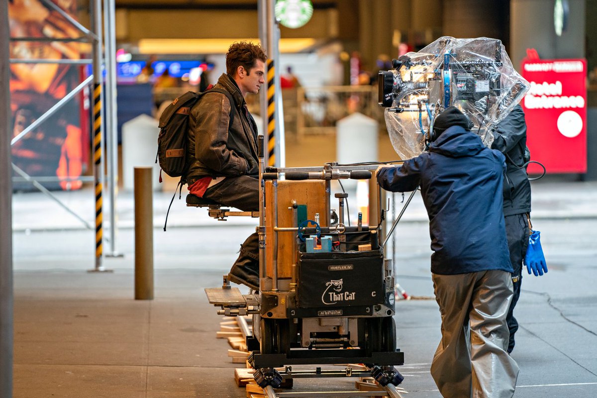 Andrew Garfield sitting on a dolly track in Shubert Alley