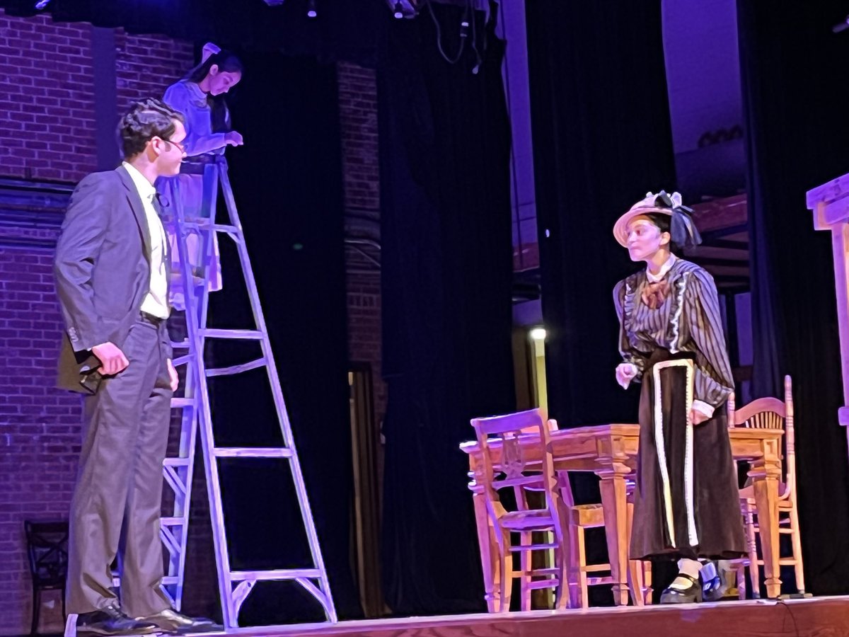 Mrs. Gibbs (Amany) trying to get Doc Gibbs (Jeffrey) to stop working so hard and take a vacation.  In the background, Emily (Kajal) does her homework, completely unaware of her future that awaits her. #thewheatleytheatrecompany #eastwillistonlearns