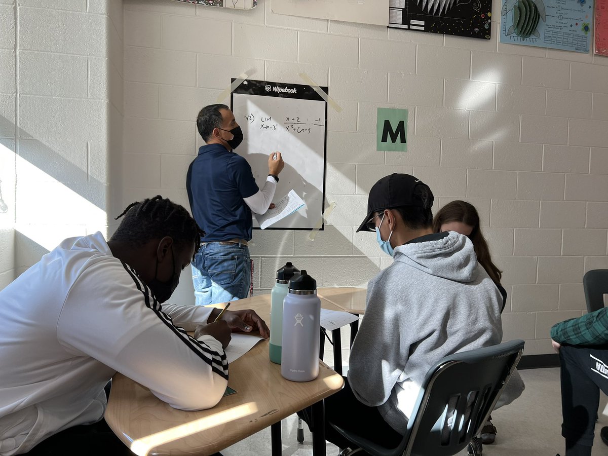 Mr. Avalos is working with a small group of students in his “Meet the Teacher” station of the math workshop model in Calculus