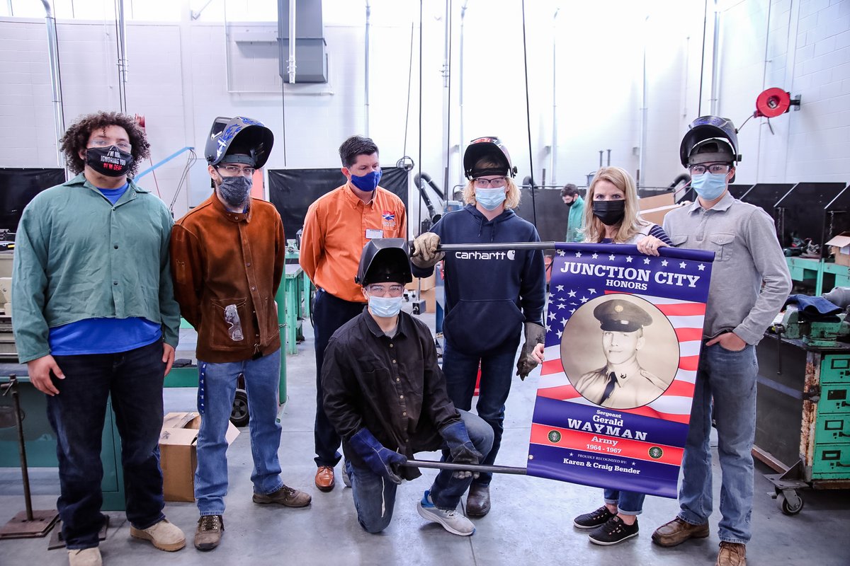 USD475's tweet photo. The @jckschamber presented @junctioncity_hs' welding class with a Certificate of Appreciation for their work in making the brackets to hold the banners for the Veterans Day Tribute downtown! #BeBoldBeBlue #ThriveIn475 https://t.co/8uiygbe2I0