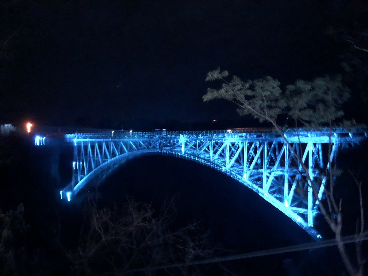UNICEFZIMBABWE's tweet photo. Zimbabwe’s iconic Victoria Falls bridge bursts to blue in solidarity with child rights and reimagining a better future #foreverychild 

#WorldChildrensDay https://t.co/wJz7vPkiEK