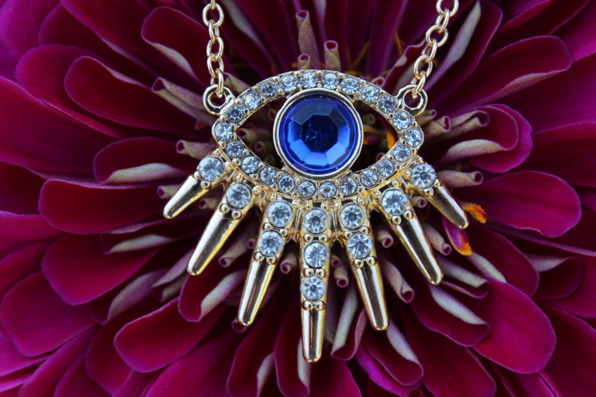 A Real Eye Catcher! Brilliant Blue Synthetic Sapphire Evil Eye in a Gold Setting Embellished with Multiple Crystal Rhinestones! Comes with Matching Crystal Rhinestone Post Earrings. fringeflowersandfrills.com/epages/2121588… #evileye #evileyenecklace #protection #protectingmypeace #spiritual