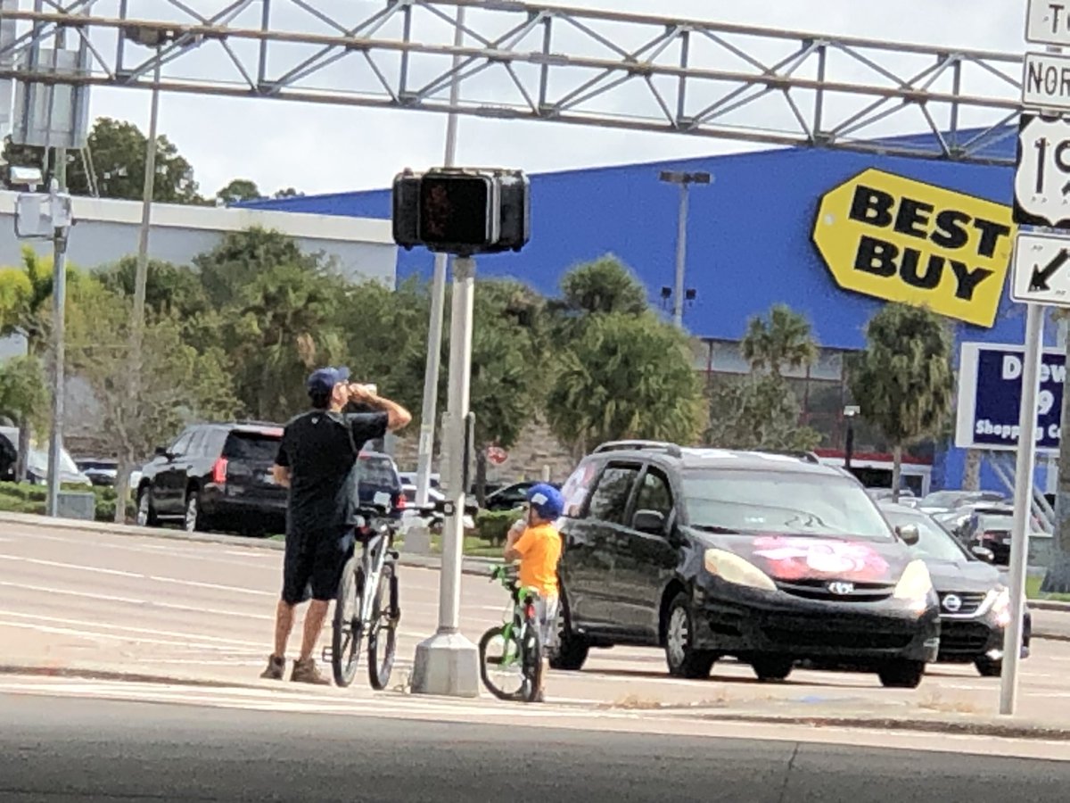Whitbone's tweet photo. Just a father and son riding their bikes on #DrewStreet underneath #US19 in #ClearwaterFL. A programmed resurfacing project from here to #SunsetPointRoad needs to make the US19 frontage roads safer and accessible for everyone. @MyFDOT_Tampa @MyClearwater @PinellasCoNews https://t.co/VOYkZfyQtE