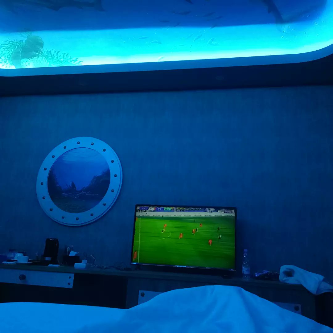 JohnDaviesIndo's tweet photo. Tinted submarine blue lit, laying cosy in bed watching a bit of Serie A whilst Joe decided to chill out on the leather sofa/bed thing and play Tofu O'Sushi 2. This is the life 😂 #cosynightin #footy #chilling #gaming #jamboolandwaterpark #jambooland #jamboolandtulungagung https://t.co/xYAip0xPSi
