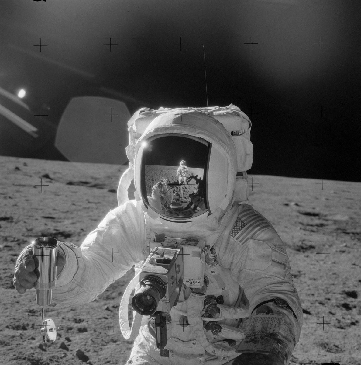 NASA photograph of astronaut Alan Bean on the moon, with a reflection of astronaut Pete Conrad visible in his visor.