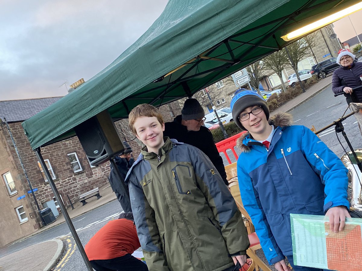 NorthAbshireMC's tweet photo. Drew Lawson and Logan Mair, 2 of our young music centre members braving the rain to play with Turriff Silver Band today at the Xmas light switch on!! #music #band #abshire #musiccentre #youthmusic #brassband #xmas https://t.co/z76cCsvpMg