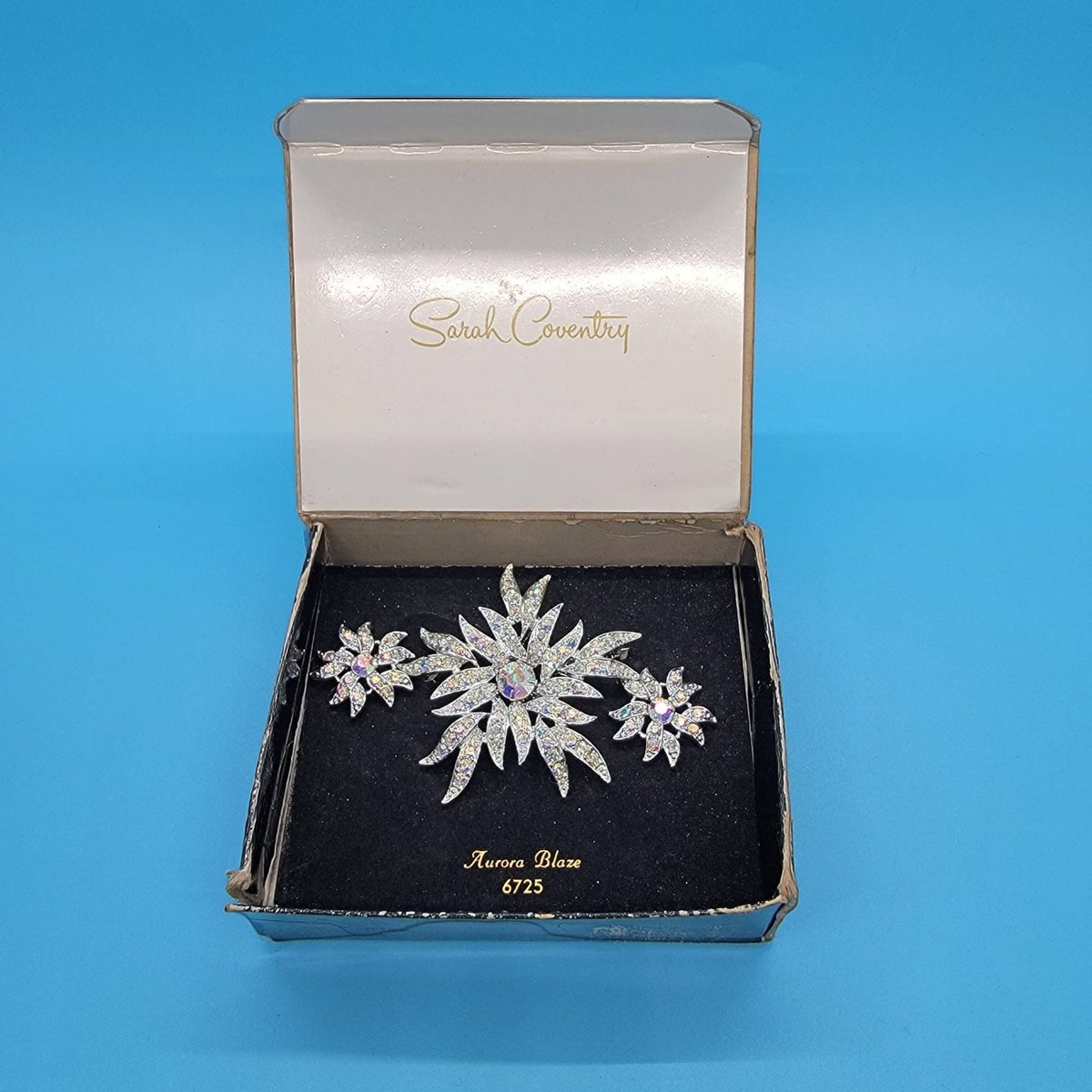 LoveAndDust's tweet photo. New to Love and Dust today! This Sarah Coventry brooch and earring set from 1967 has stunning aurora borealis stones that glitter like they were made yesterday. Great to wear to a holiday party or give as a gift. #midcentury #sarahcoventry #auroraborealis #abjewelry https://t.co/Ot3lf8VwhA