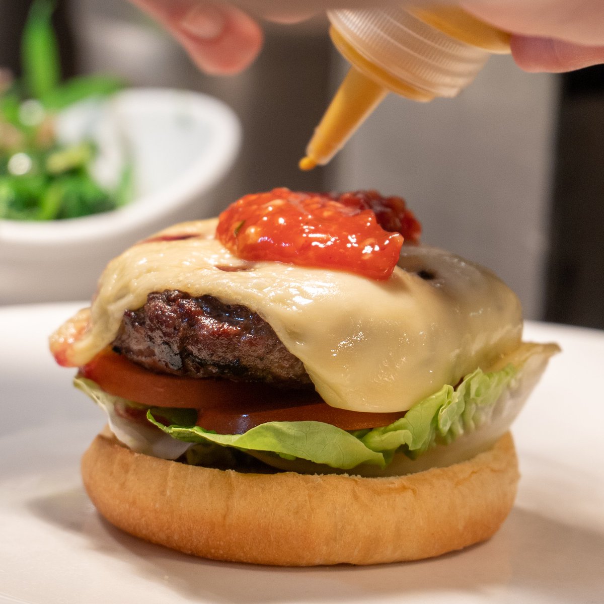 Putting the finishing touches to our delicious burger 🍔