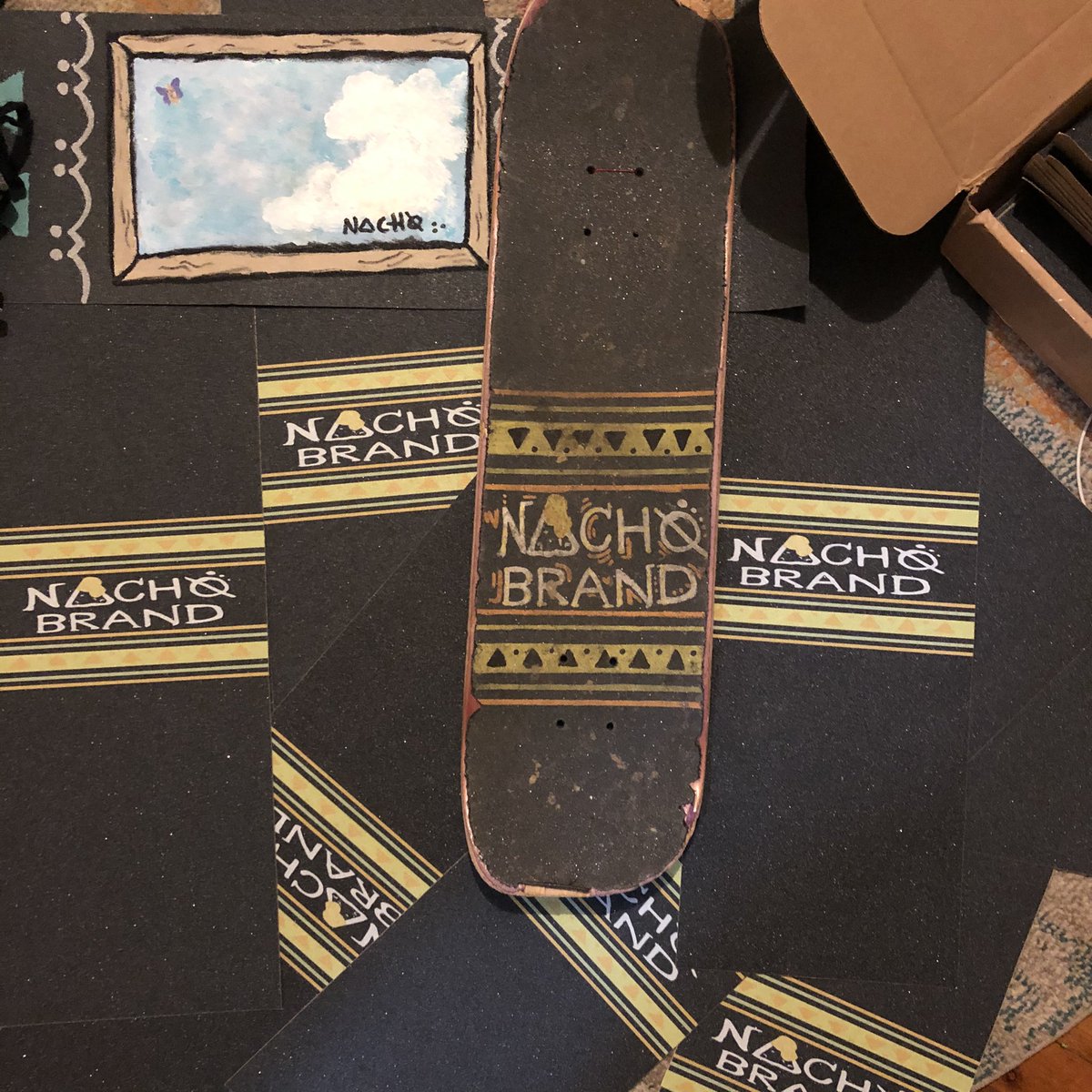 YedaLens's tweet photo. @NachoBrandco first ever OFFICIAL NACHØ Stamp Graphic Griptape 😭🧡🧀💛 has been a dream of mine since 2015 and it’s so surreal to hold and look at these. it’s just the first run &amp; cant wait to improve and see what’s next. ❤️ shoutout to the homies who helped me make this happen https://t.co/fQLlSVmPt5