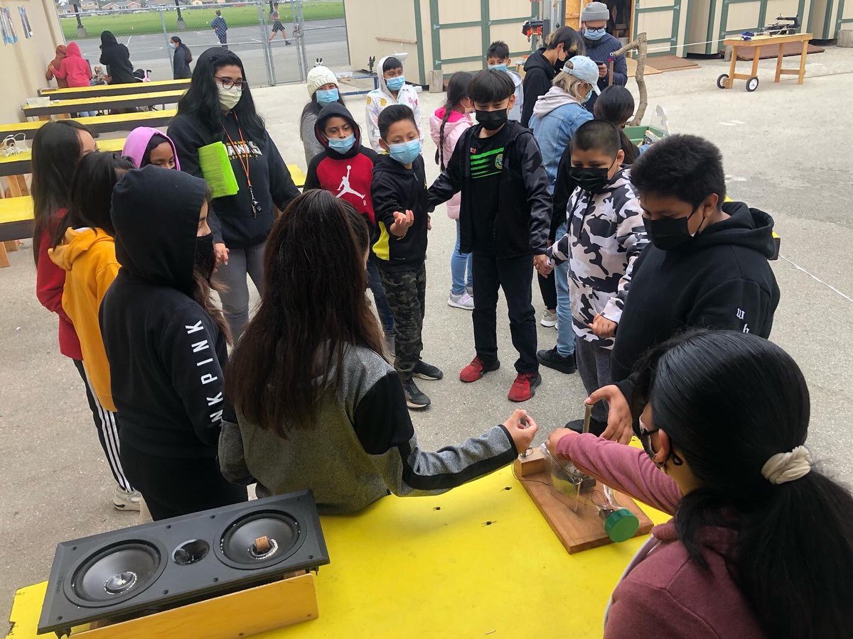 CSWSalinas's tweet photo. Subtle but sublime: the moment before a 10 person shock, Hartnell and CSUMB students teaching our crowd bio-mathematics with bead bracelets, anatomically correct hand models, and one lucky kid getting a scalp massage from his buddies’ newly made finger models. https://t.co/R5aA7ZntVl