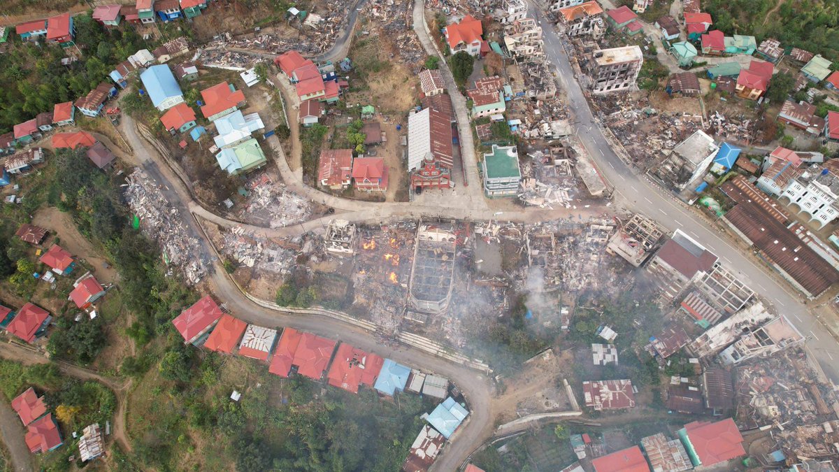 ChinHumanRights's tweet photo. Aftermath: Small flickers of fire can be seen from United Pentecostal Church and its clergy quarters  burned to ashes in junta's continuing assault on Thantlang town. A total of 19 structures were destroyed in the latest attacks yesterday. https://t.co/hB37jG9ZiU