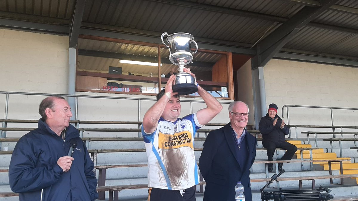 Dan Kelleher, captain of <a href="/brosnagaels/">Brosna Gaels</a>, lifts the Cup after the <a href="/MolloyPrecast/">Molloy Precast & Environmental Systems</a> Junior A Hurling Championship final replay in St Brendan's Park, Birr.
Pictured with Paddy Scales of Offaly County Board and Donal Molloy, sponsor.