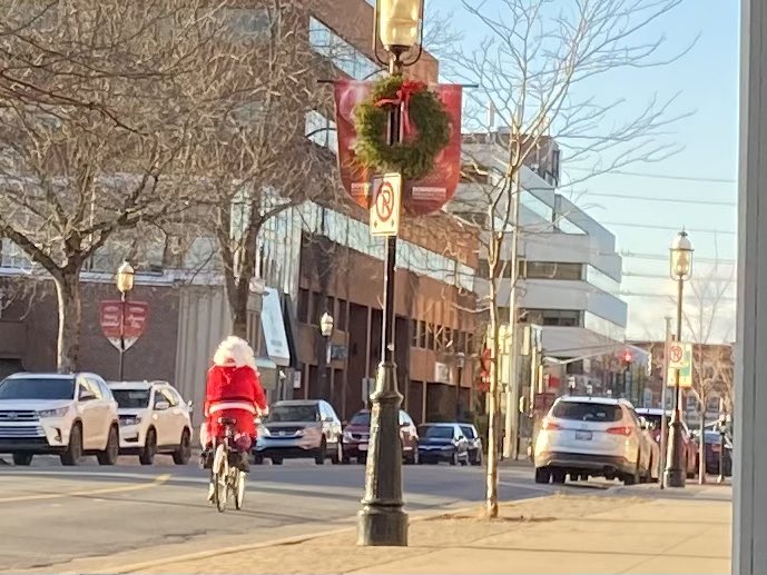 Spotted Santa 🎅 biking in downtown #Fredericton today. 

Maybe the sled’s in the garage? 🤔