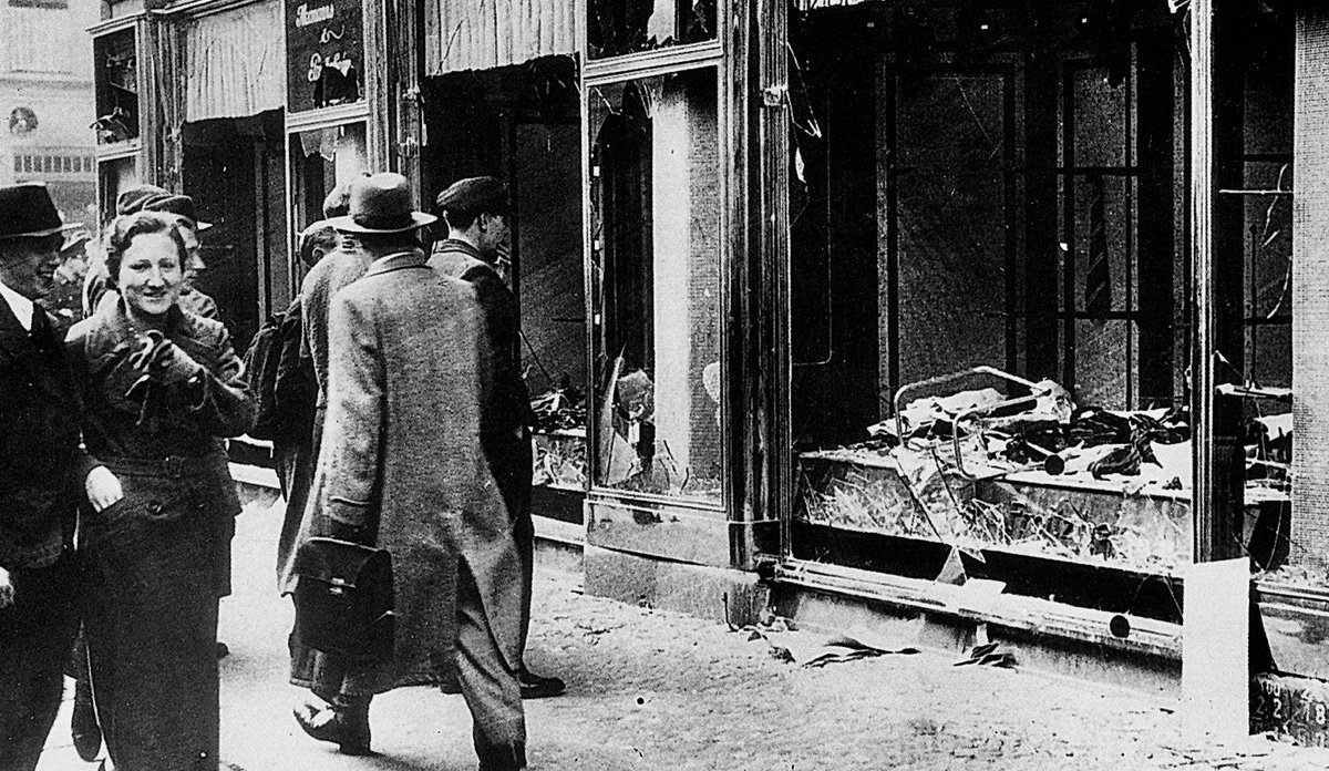 After Kristallnacht 1938, passersby in Berlin react to destruction of a Jewish-owned business: