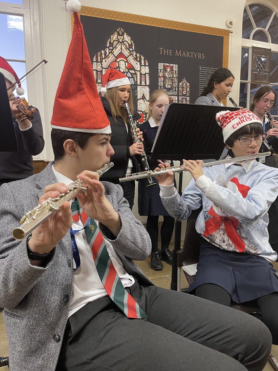 SECMusicSchool's tweet photo. We're getting into the #Christmas spirit with the Orchestra playing carols and festive tunes around the Christmas tree. #Carols #fun #ChristmasJumpers https://t.co/wRC7eBzgxO