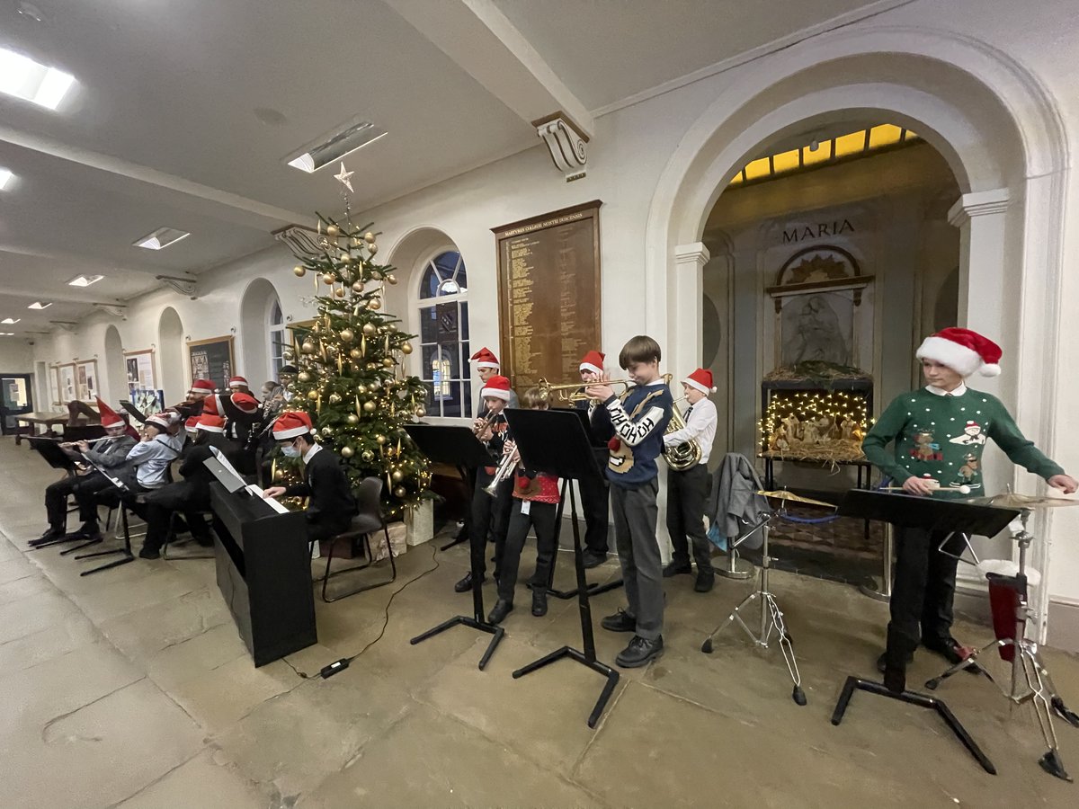 SECMusicSchool's tweet photo. We're getting into the #Christmas spirit with the Orchestra playing carols and festive tunes around the Christmas tree. #Carols #fun #ChristmasJumpers https://t.co/wRC7eBzgxO