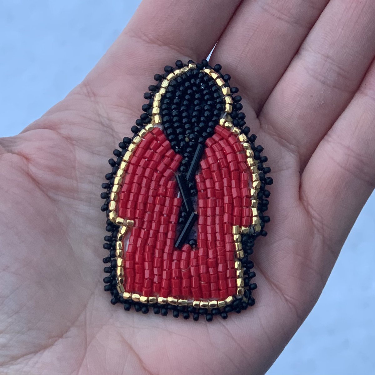 Today, I'm wearing this beautiful beaded pin that my friend Azure gifted  me. The red dress represents the thousands of missing Indigenous people  across Turtle Island. Azure shared with me that this