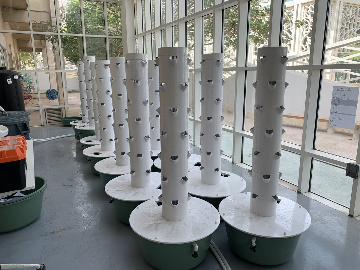 TAMUQ's tweet photo. Benjamin Cieslinski and Mohamed Gharib from our STEM Outreach team volunteered their expertise at @QF’s @awsajacademy, constructing and installing the school’s new vertical micro-farm where students and teachers will be able to grow plants using recycled water and nutrients. https://t.co/bRdNCzGGqJ