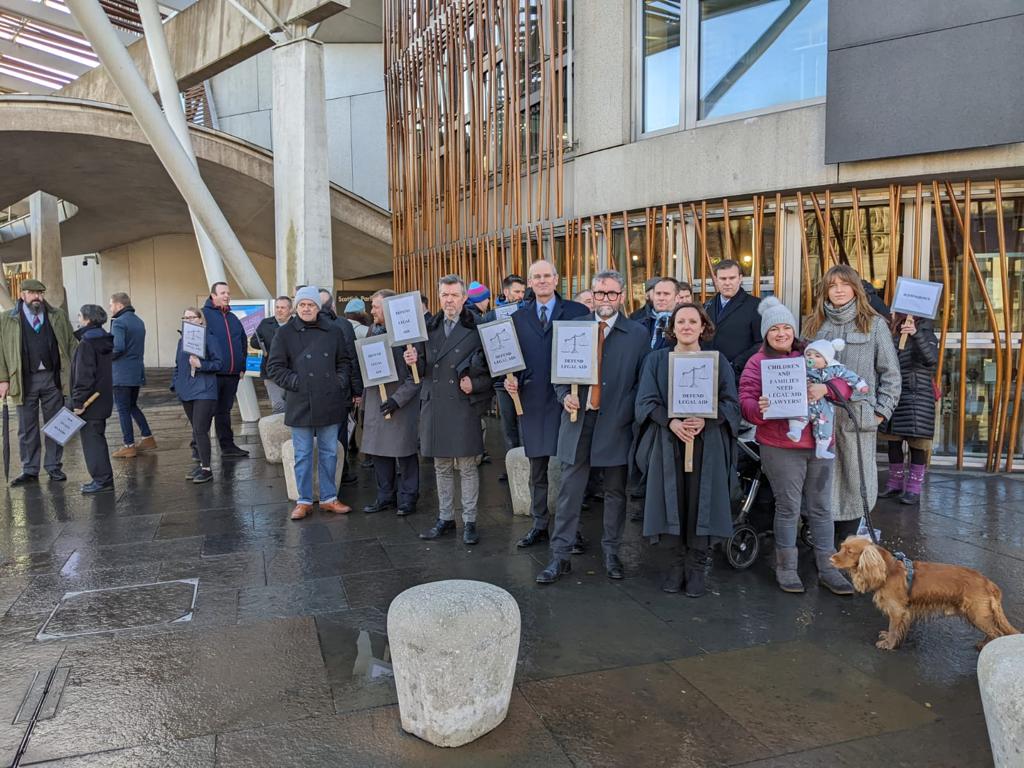 scotscrimbar's tweet photo. Dozens of solicitors braved the icy conditions outside the Scottish Parliament today to protest against @ScotGovJustice continuing failure to address the crisis in criminal legal aid. The protest coincides with a mass boycott of holiday custody courts all over the country. https://t.co/hOsBgVzSZX