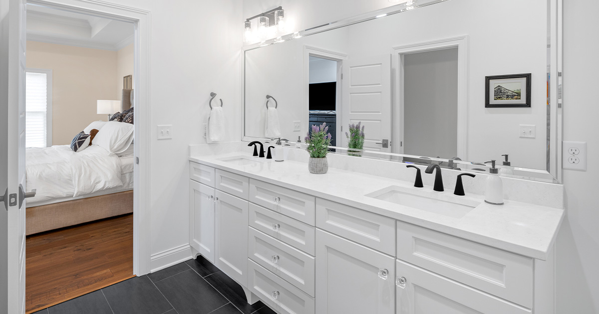 This bright, clean bathroom is anchored by black tile. The dark floor is mirrored in minimalist matte finish sink fixtures, and crystal hardware adds a dramatic flair to the simple cabinets.

See more of this farmhouse: wielandbuilders.com/our-work/ranch…

Photo Credit: @grupenhof_photo