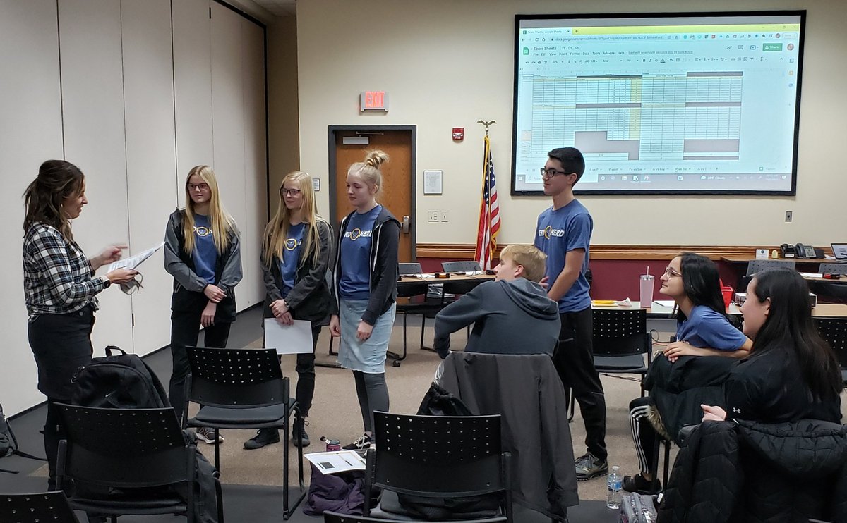 The Nerd Herd listens during a strategy session with quiz advisor/coach Ms. Dorosz after beating Wauseon, as they prepare to play Swanton in their next match at the Fulton County Quiz Tournament held at the NWOESC.