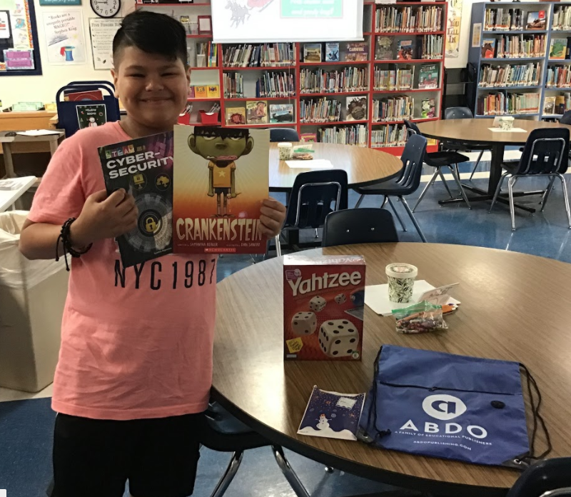 McQElemLibrary's tweet photo. 5th grader Rolando is our 3rd winner in our "12 Days of Giveways" event! Rolando won a board game, two books, and a goody bag! @MatsRead @SeguinISD @McQueeneyESISD #12DaysofReading #SeguinReads #1Heart1Seguin #MightyMcQueeneyMatadors https://t.co/DamcsSdK9x