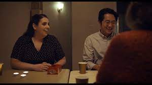 Beanie Feldstein and Steven Yeun in THE HUMANS.