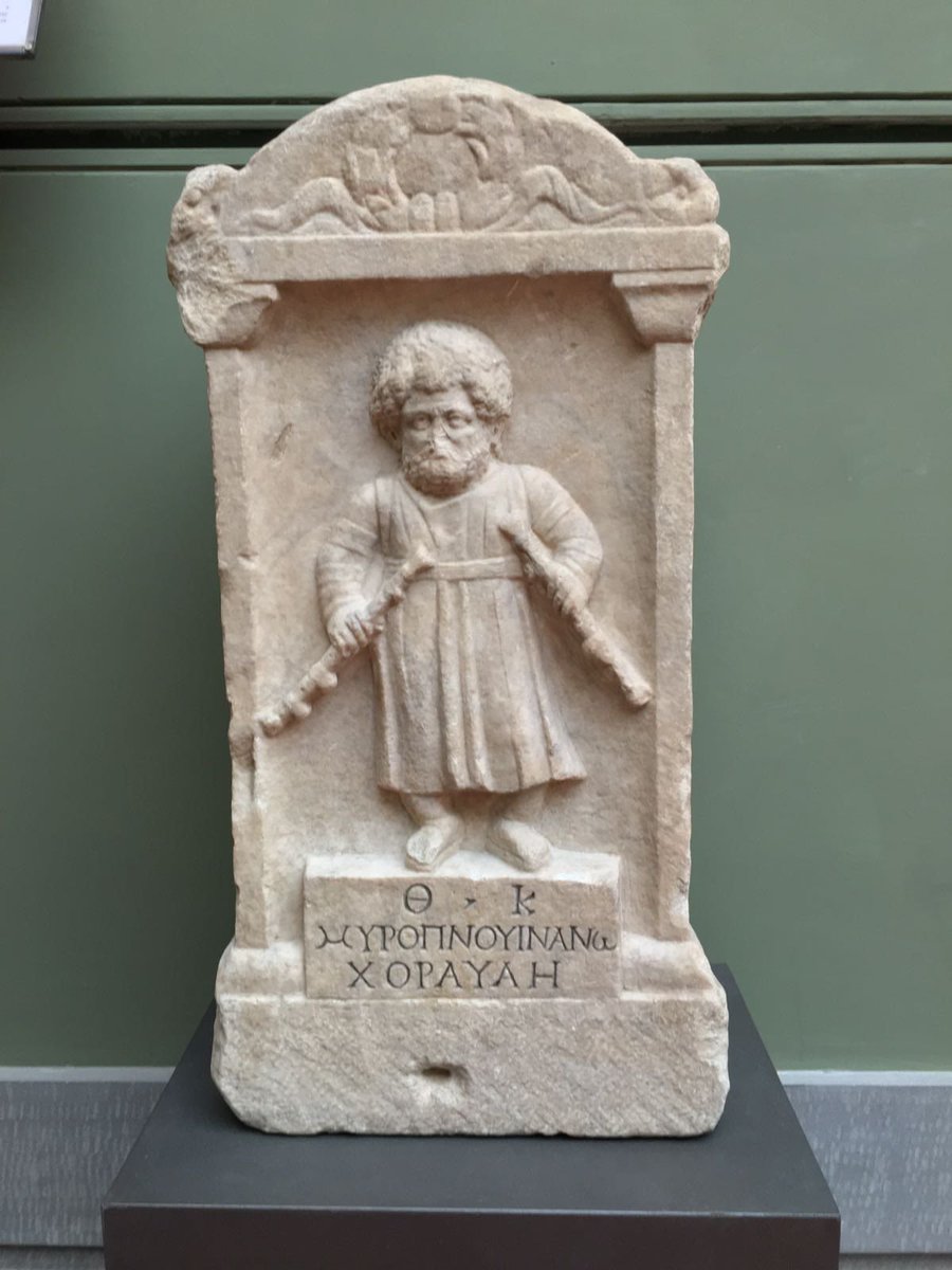 Artefact of the day. Memorial to the dwarf flute player Myropnous found on the Via Appia, Rome. The deceased, likely a servant, is seen holding a pair of Auloi which played a very important part in public life, religious ceremonies &amp; the theatre. #Roman #ancientrome #sculpture