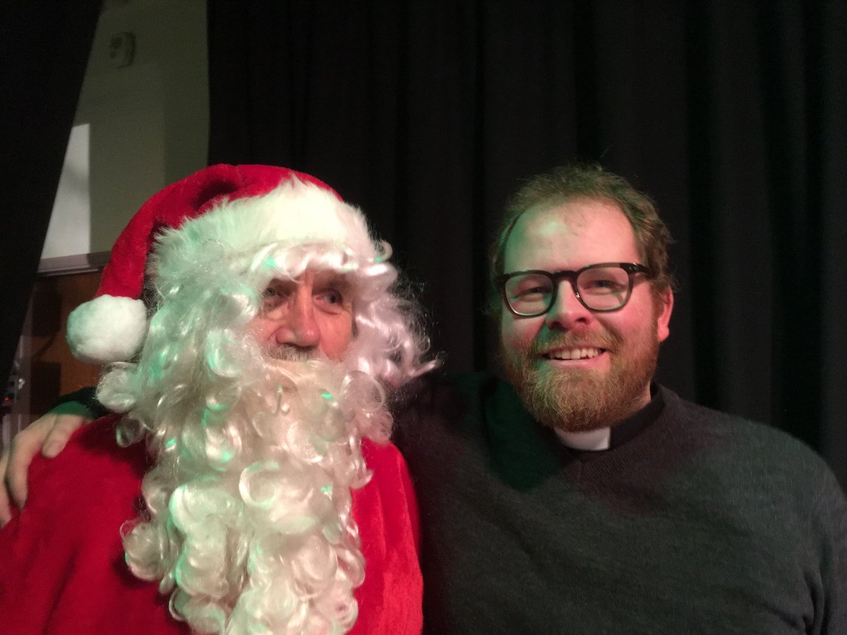 LexdenChurch's tweet photo. The St Leonard's #Christmas Fayre is almost here.  Please help us spread the word and do join us on the day! #Colchester #Cake 
(n.b. Vicar/Father Christmas pic from the pre-Covid era) https://t.co/BXWmhIqux9