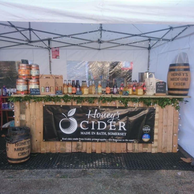 HoneysCider's tweet photo. Queens Square in our beautiful Bath is home for the next 4 weeks @bathartisan Christmas Market. Come see us for all your cidery needs and a hot mulled cider to keep you warm (except Mondays and Tuesdays as no alcohol stalls can trade so we'll be busy prepping stock instead) https://t.co/Tn7JnkU8Sr