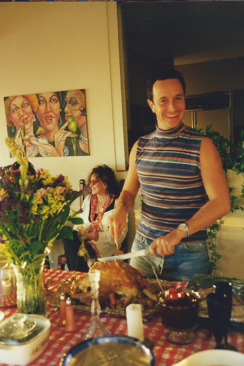 PaulyShore's tweet photo. Here’s a classic turkey shot. Me carving up the bird, mom in the background laughing. Have a great #Thanksgiving everybody https://t.co/zNrI9KFip2