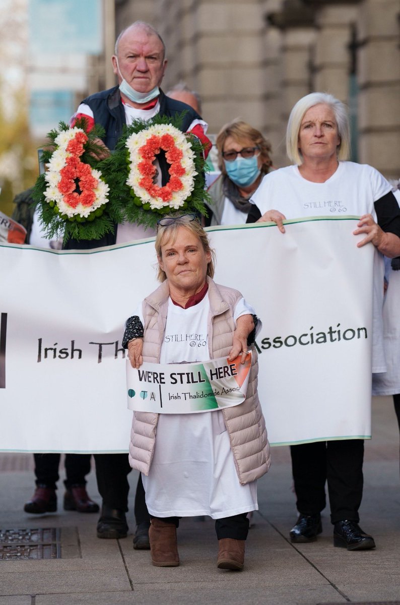 ThalidomideIre's tweet photo. Survivors gathered today at LH to note the 60th anniversary of the international withdrawal of Thalidomide; remembering those who have died; and those of us  who are not dead yet. We still await an apology, justice and fairness from the State. https://t.co/iQzXsYMZjA
