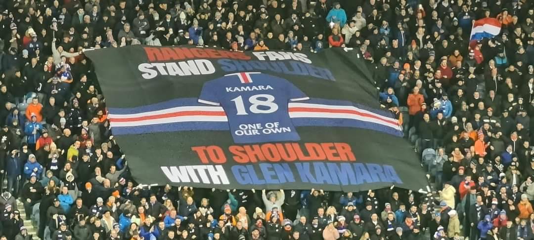 bluesbrothers86's tweet photo. Rangers fans stand shoulder to shoulder with Glen Kamara banner at Ibrox tonight! 💙 https://t.co/mwy5yyRLN2
