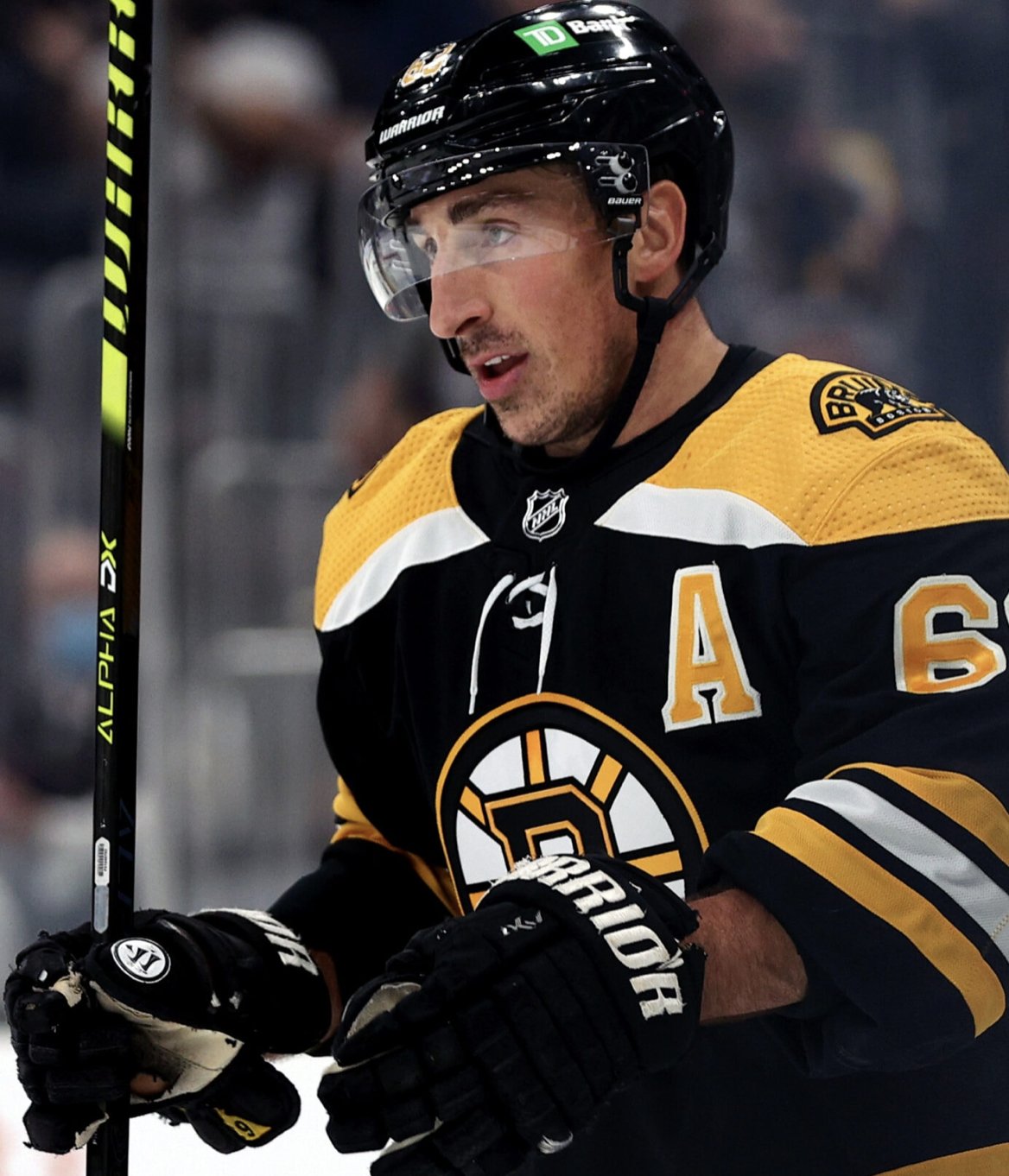 Looks like Marchand is using his black gloves with some kind of