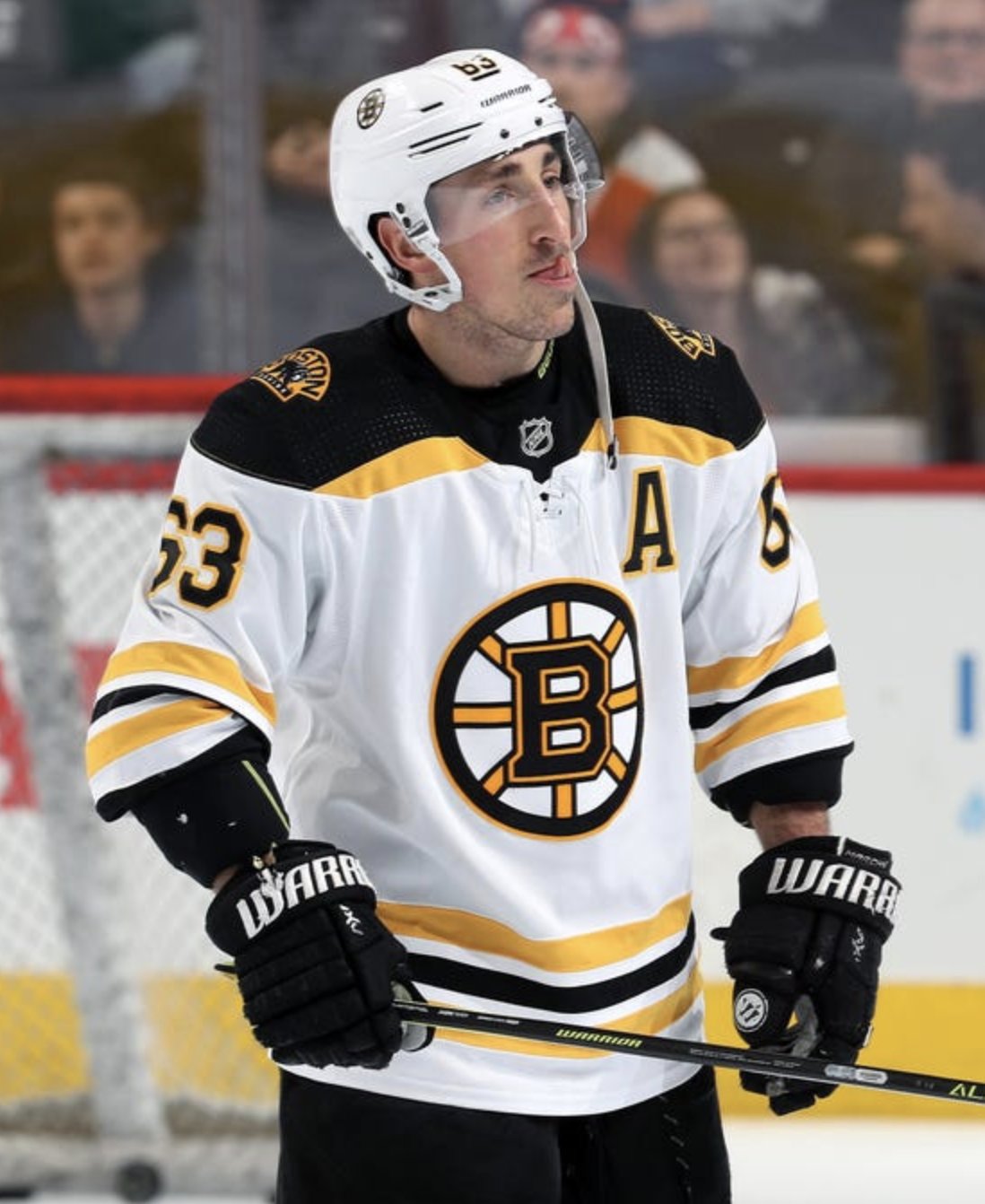 Looks like Marchand is using his black gloves with some kind of
