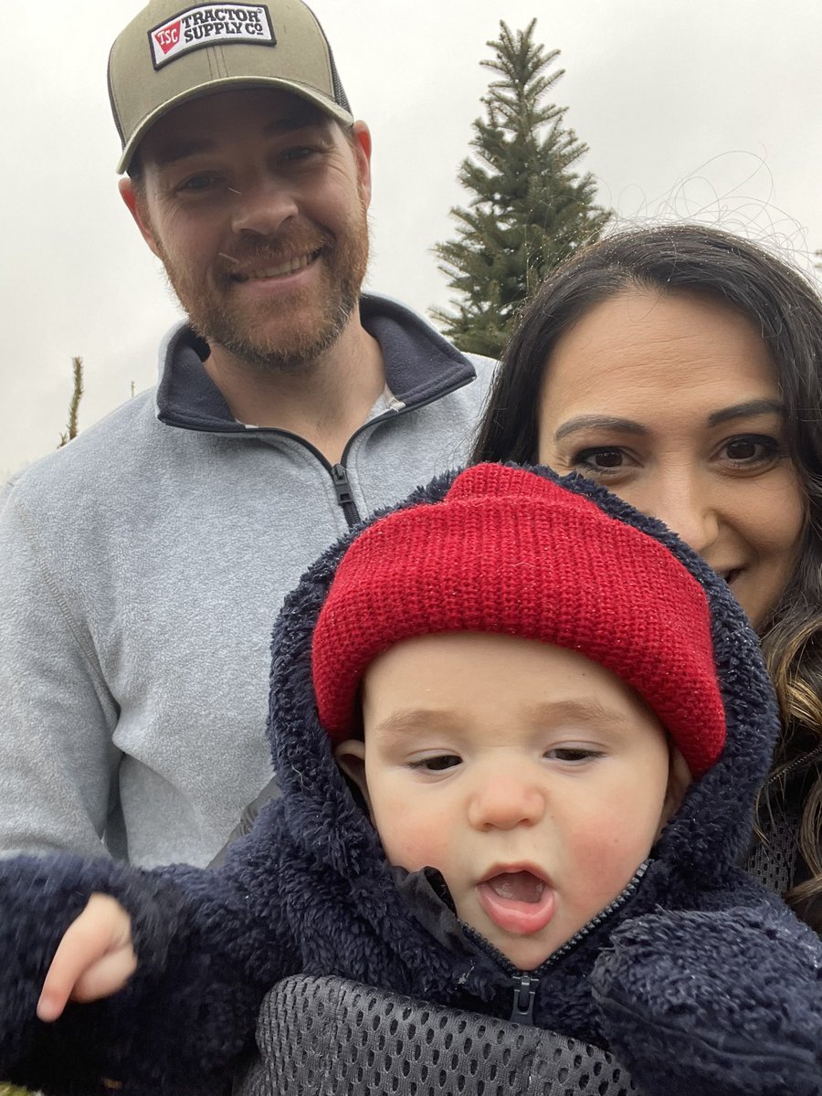 Who else is braving the rain for a tree today?! Tradition is tradition! That’s our tree behind us lol🎄