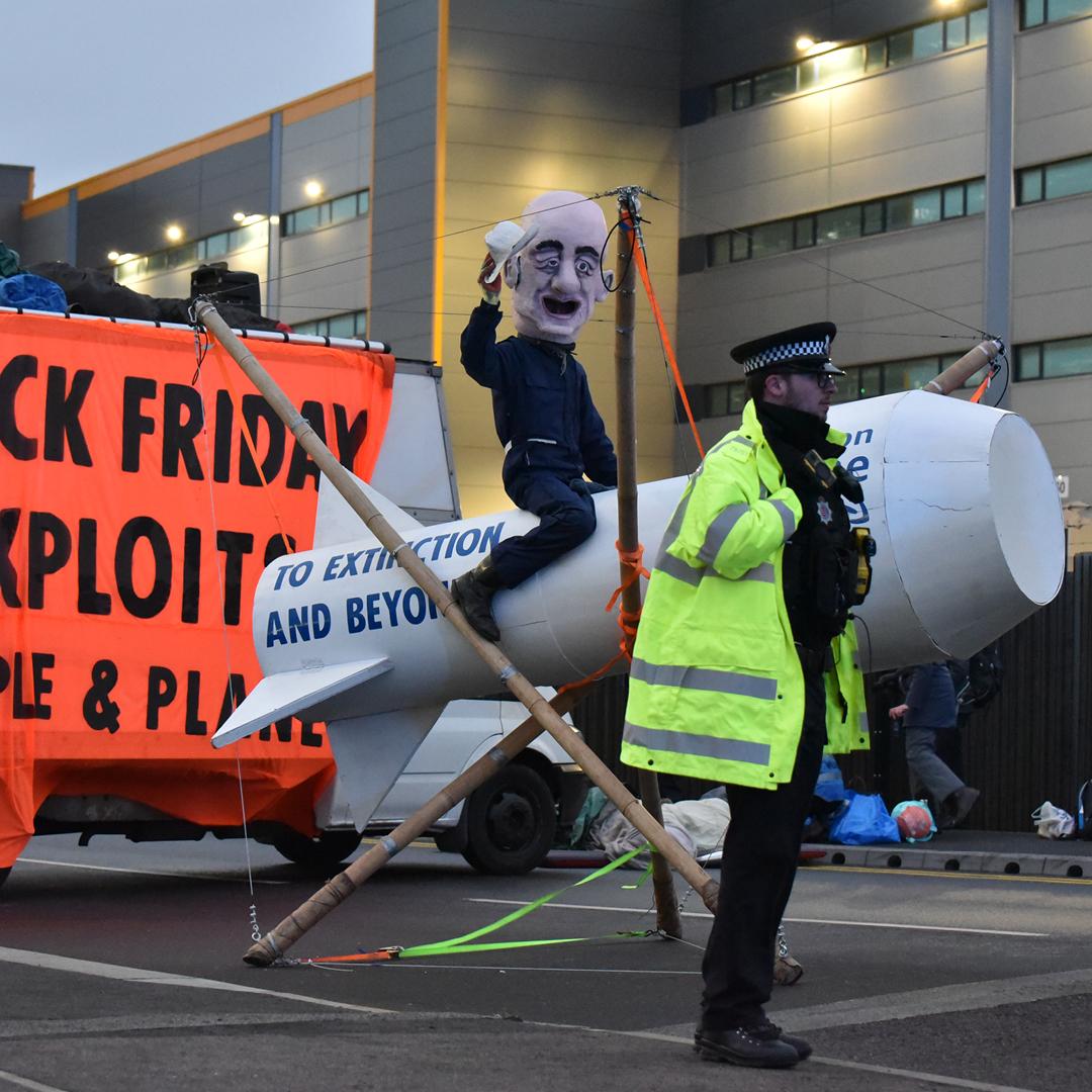 XRebellionUK's tweet photo. Despite almost 60 arrests 6 @amazon warehouses remain blocked in the UK as #ExtinctionRebellion took action against over 50% of their UK sites today to confront a company that steals from the people to fuck the planet. #BlackFridayAmazon #MakeAmazonPay #ClimateCrisis #ActNow https://t.co/Pk1sTbqdNT