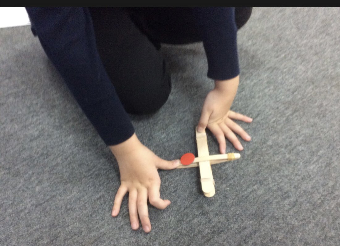 EPA_Y1_Y2's tweet photo. #EPADolphins looked at how we could change the shape of objects by adding more sticks to a catapult. We learnt that the more sticks we added, the tighter the band! The counters seemed to go even further too! #EPAScience @DeltaEstcourt https://t.co/1llEaIVdsQ