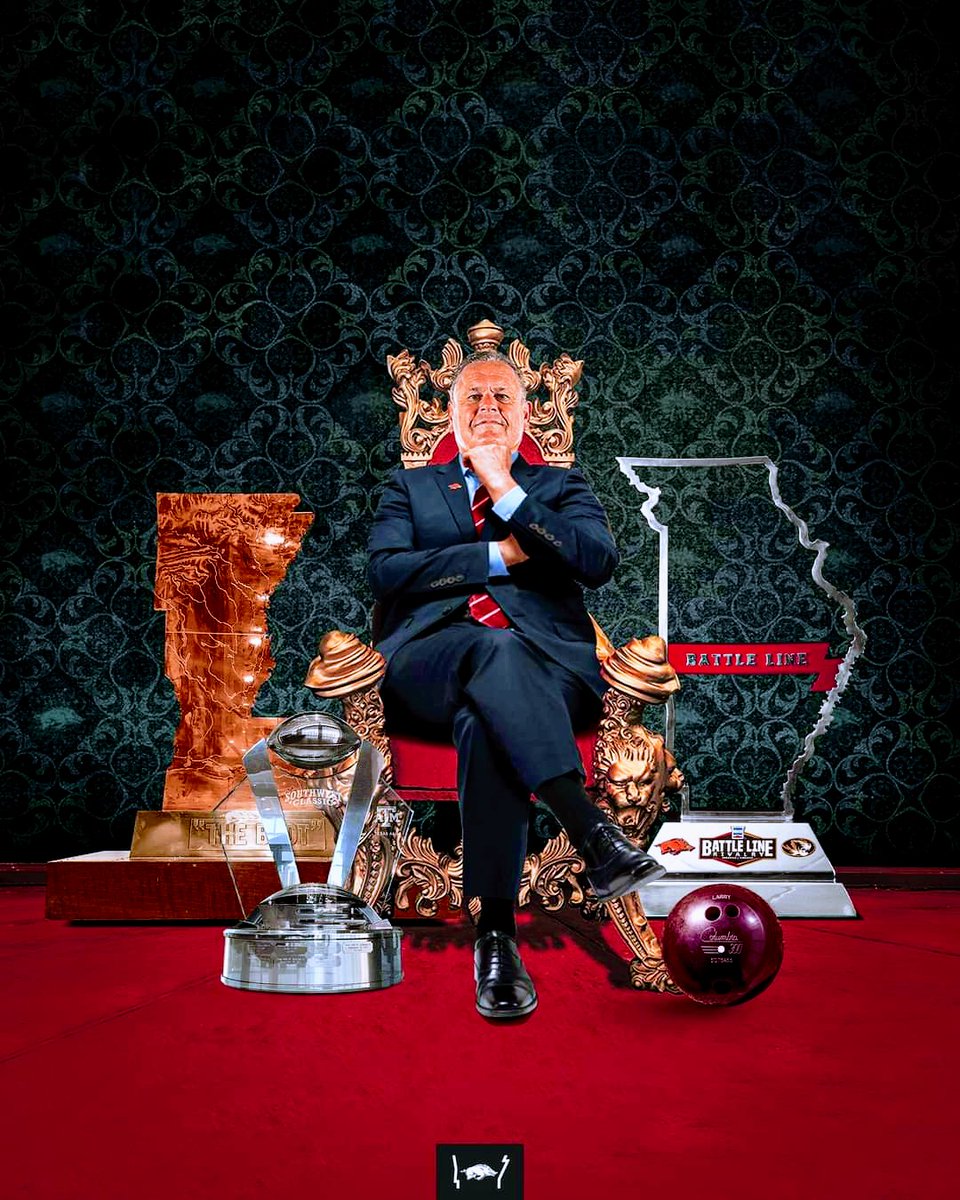 RazorbackGrind's tweet photo. I'm going on record and coining the phrase The Hogfather for Sam Pittman... Tell me he doesn't look like he's made you an offer you can't refuse in this pic? 3 trophies in the same season never happened before! #WPS https://t.co/CtJxp4rg91