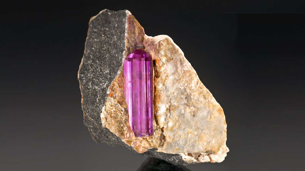 GIAnews's tweet photo. Seen here is a vivid purplish-pink crystal contained in matrix from Mardar, Pakistan. Purplish-pink is one of the rarer topaz colors of topaz. Learn more about topaz: https://t.co/DmxrNCSVtc Photo: Robert Weldon. Courtesy: William F. Larson https://t.co/BVaFqVis0Q