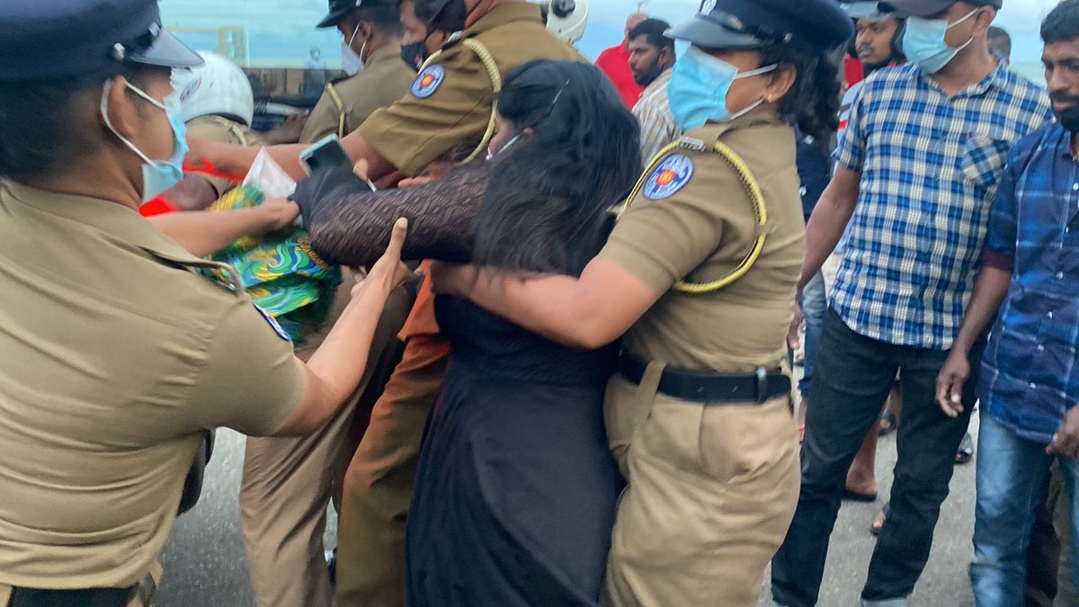 JDSLanka's tweet photo. In a show of resilience &amp; courage, Ilancheliyan Binduja lights the memorial flame in memory of fallen #Tamil militants on the #Mullaithivu seafront, despite #SriLanka police arresting her husband Peter Ilancheliyan while on their way to take part in Tamil Heroes Day event. https://t.co/FptbJ36PlO